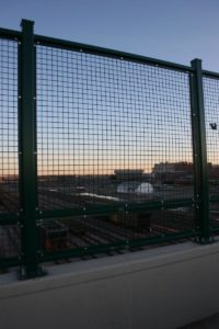 American Fence Company of Sioux City - Welded wire mesh on top of a pedestrian bridge